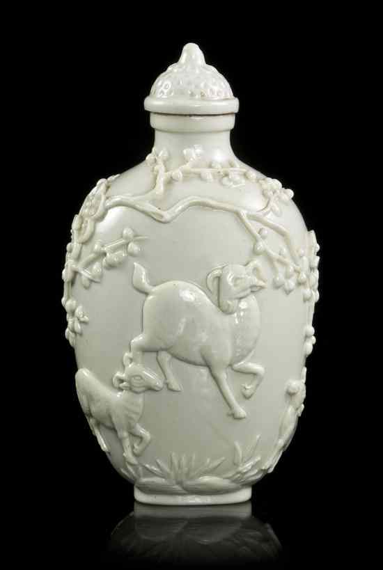 Appraisal: A Molded White Porcelain Snuff Bottle depicting three rams amongst