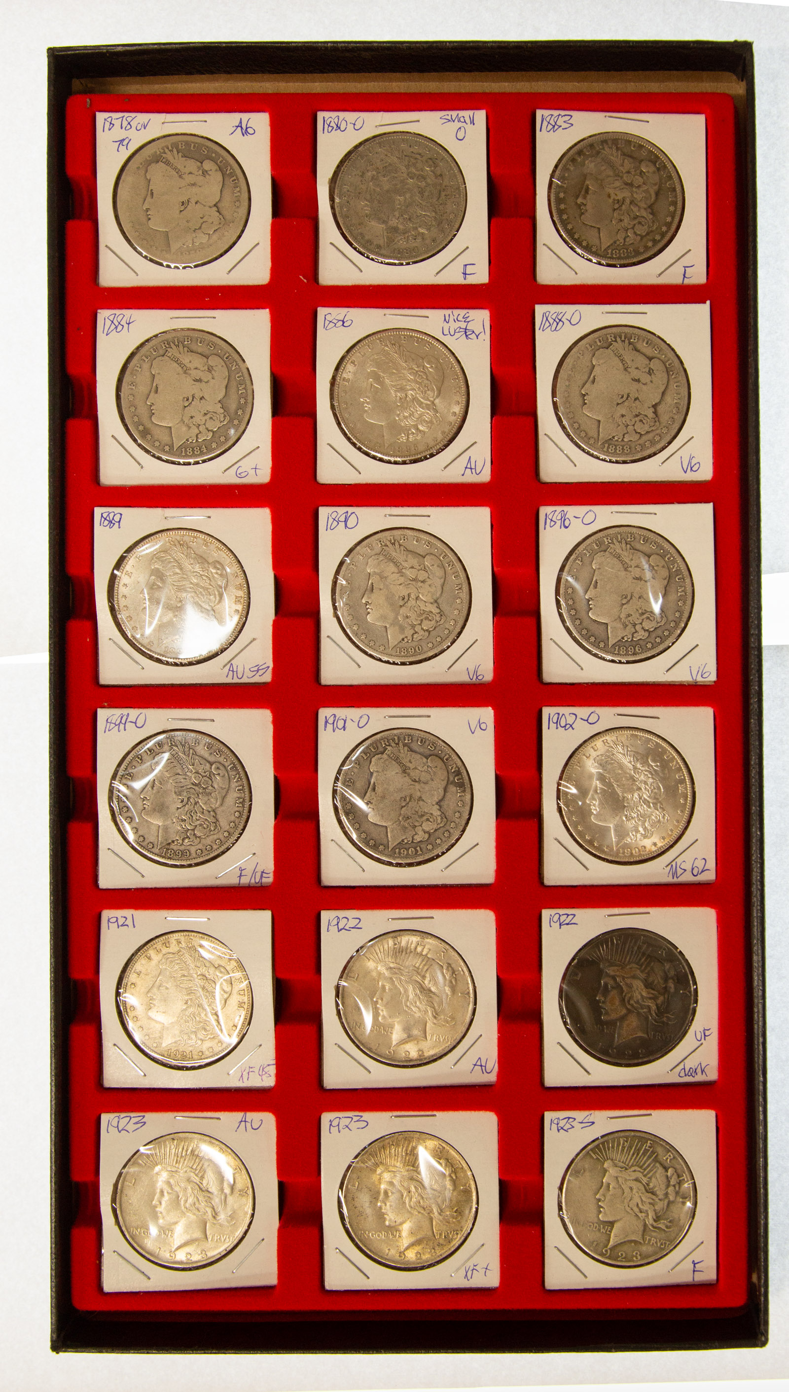 Appraisal: SILVER DOLLARS IN A DEALER DISPLAY CASE All encased in