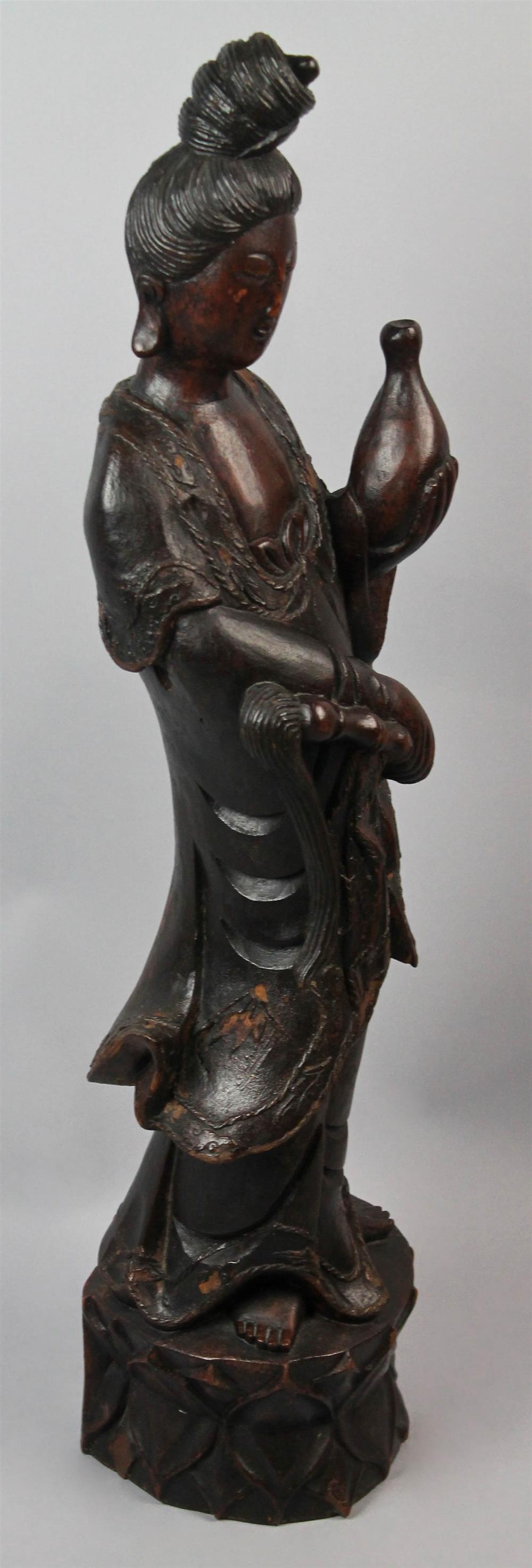 Appraisal: CHINESE WOOD CARVED FIGURE OF GUANYIN the standing goddess of