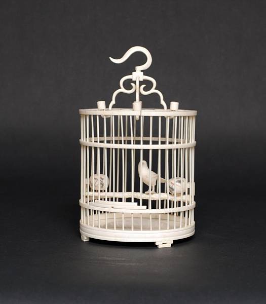 Appraisal: A carved ivory bird cage The cylindrical cage composed of