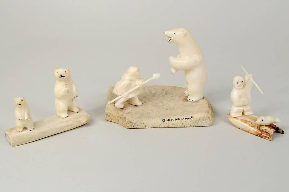 Appraisal: Three Inuit Walrus Ivory Whalebone Carvings Three Inuit walrus ivory