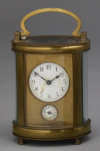 Appraisal: A French oval gilt brass carriage timepiece with subsidiary alarm