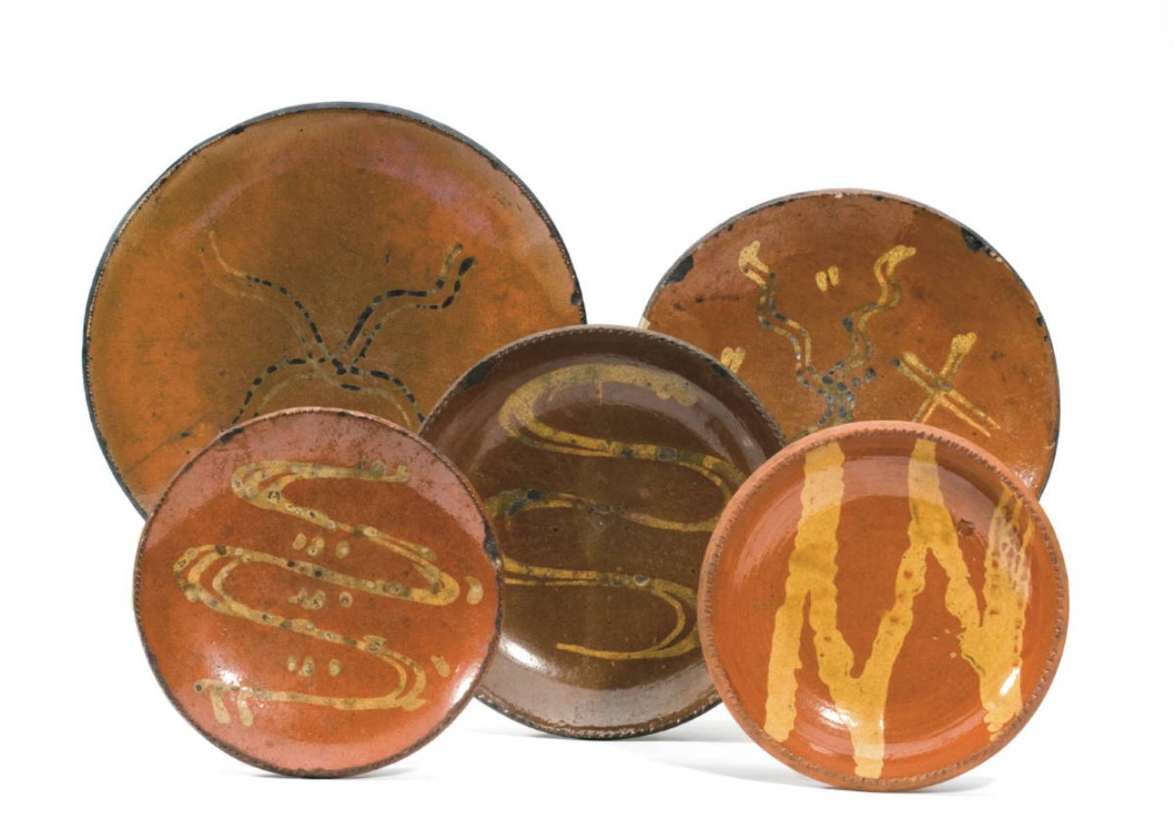 Appraisal: FOUR PENNSYLVANIA SLIP-DECORATED GLAZED REDWARE DISHES EARLY NINETEENTH CENTURY The