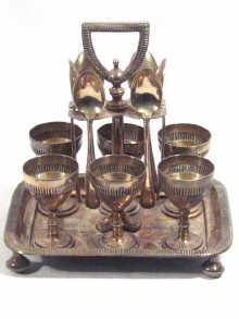 Appraisal: A silver plated egg cruet with six egg cups and