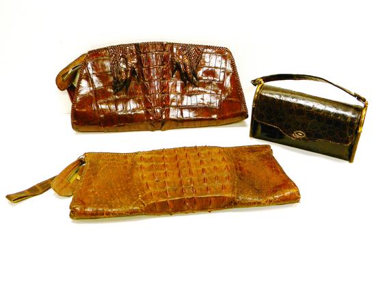 Appraisal: Three alligator purses one rounded trapezoid shaped clutch with red