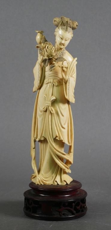 Appraisal: Ivory female figure holding flower chrysanthemum and branch on carved