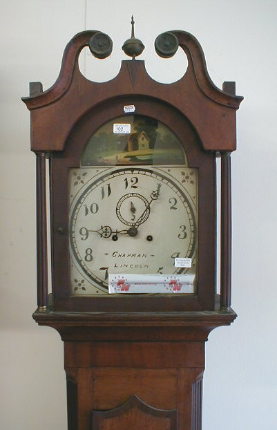 Appraisal: An early thC longcase clock with swan neck pillared hood