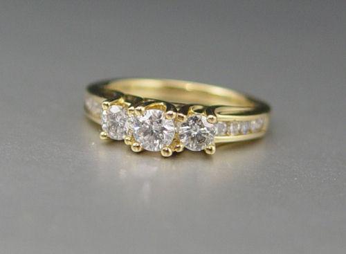 Appraisal: THREE STONE DIAMOND ENGAGEMENT RING K yellow gold ring contains