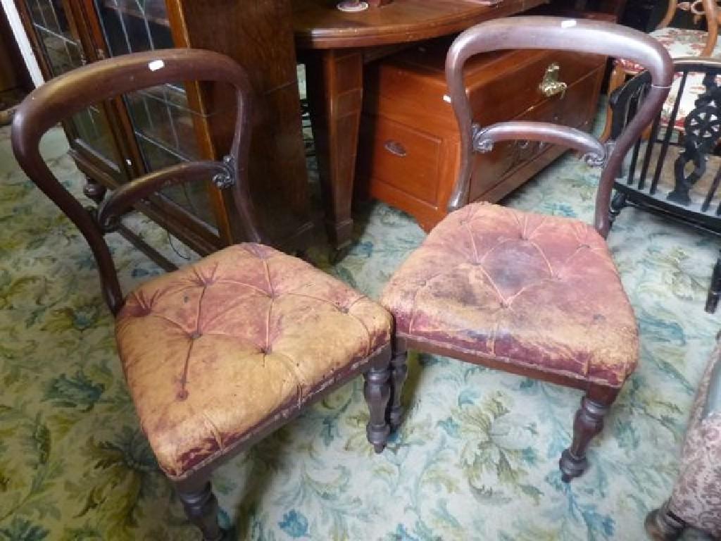 Appraisal: A pair of Victorian mahogany balloonback dining chairs with tired