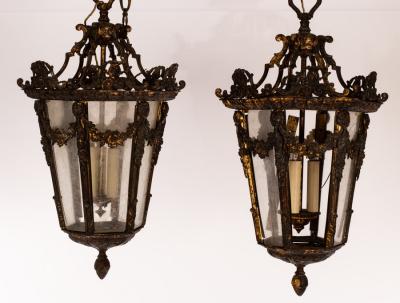 Appraisal: A pair of hexagonal tapering lanterns the oxidised frames with