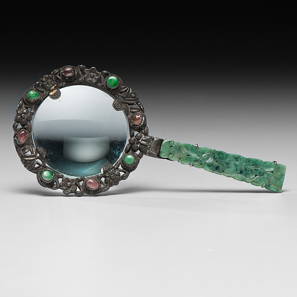 Appraisal: Chinese A magnifying glass housed in a carved metal sculpture