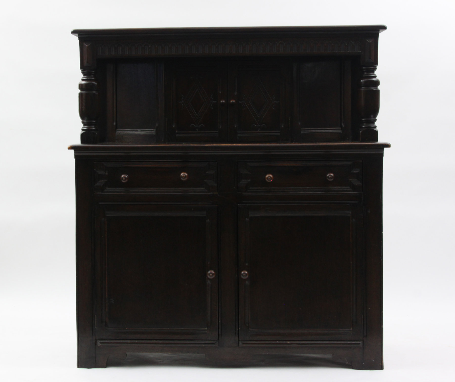 Appraisal: A carved oak court cupboard the frieze carved arches and