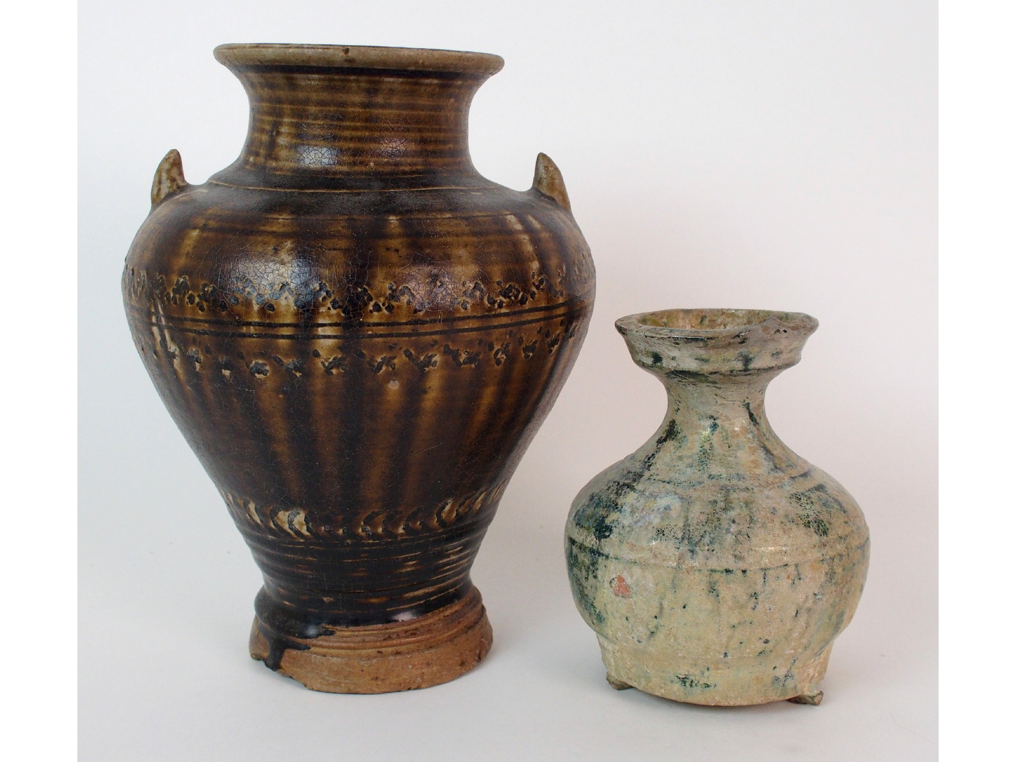 Appraisal: A Chinese treacle glaze baluster vaseincised with geometric bands with