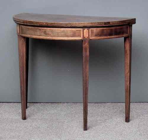 Appraisal: A George III figured mahogany semi-circular card table inlaid with