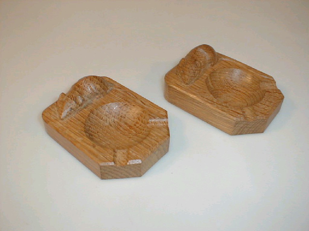 Appraisal: A pair of Thompson of Kilburn oak ashtrays carved with