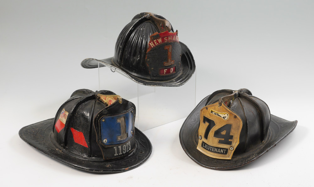 Appraisal: VINTAGE LEATHER AND METAL FIRE FIGHTER HELMETS pieces total to