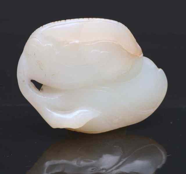 Appraisal: A CHINESE WHITE JADE PENDANT carved in the form of