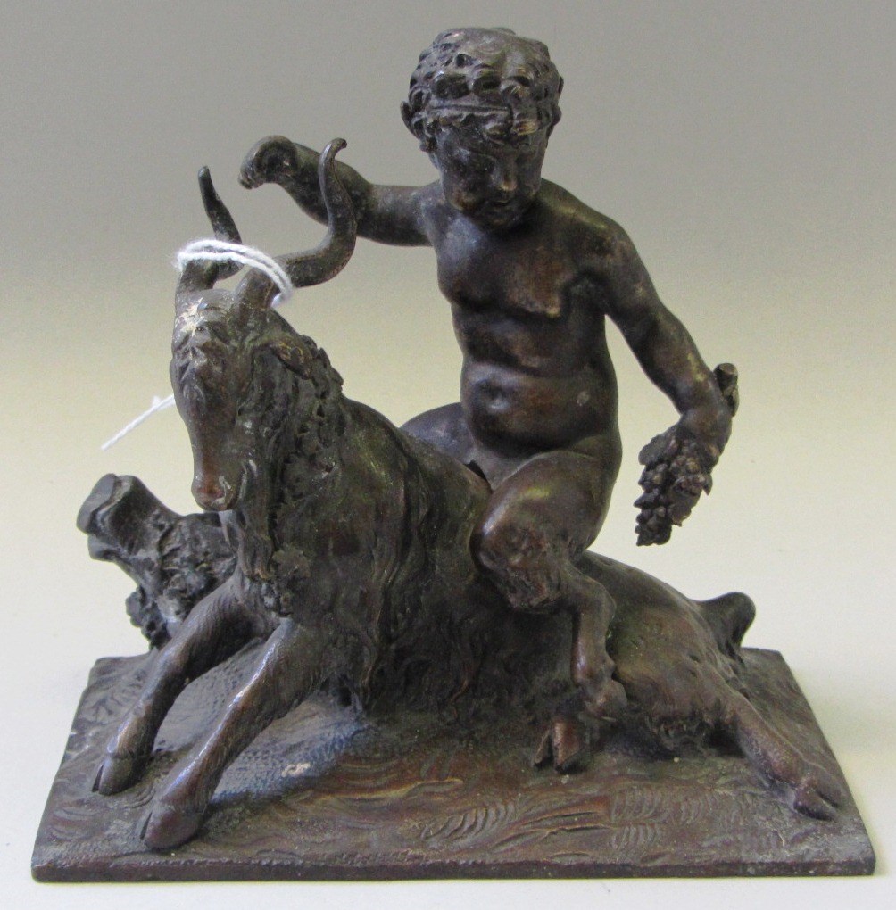 Appraisal: A patinated bronze th century modelled as a satyr atop