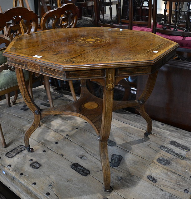 Appraisal: An Edwardian rosewood and satinwood octagonal centre tablewith inlaid fan