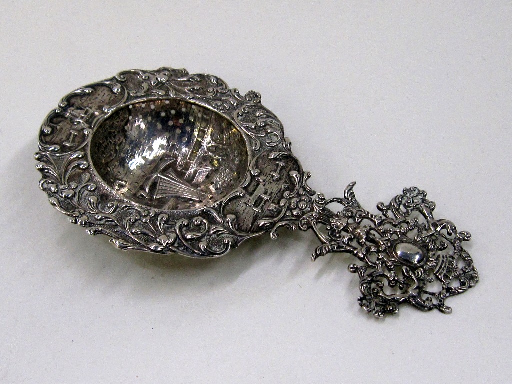 Appraisal: Lot comprising continental white metal tea strainer and a bon