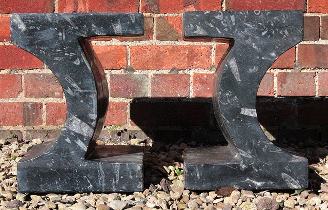 Appraisal: A PAIR OF SMALL STONE TABLE SUPPORTS with ammonite inclusions