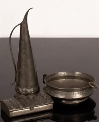 Appraisal: A pewter oil jug of slender tapering form with punched