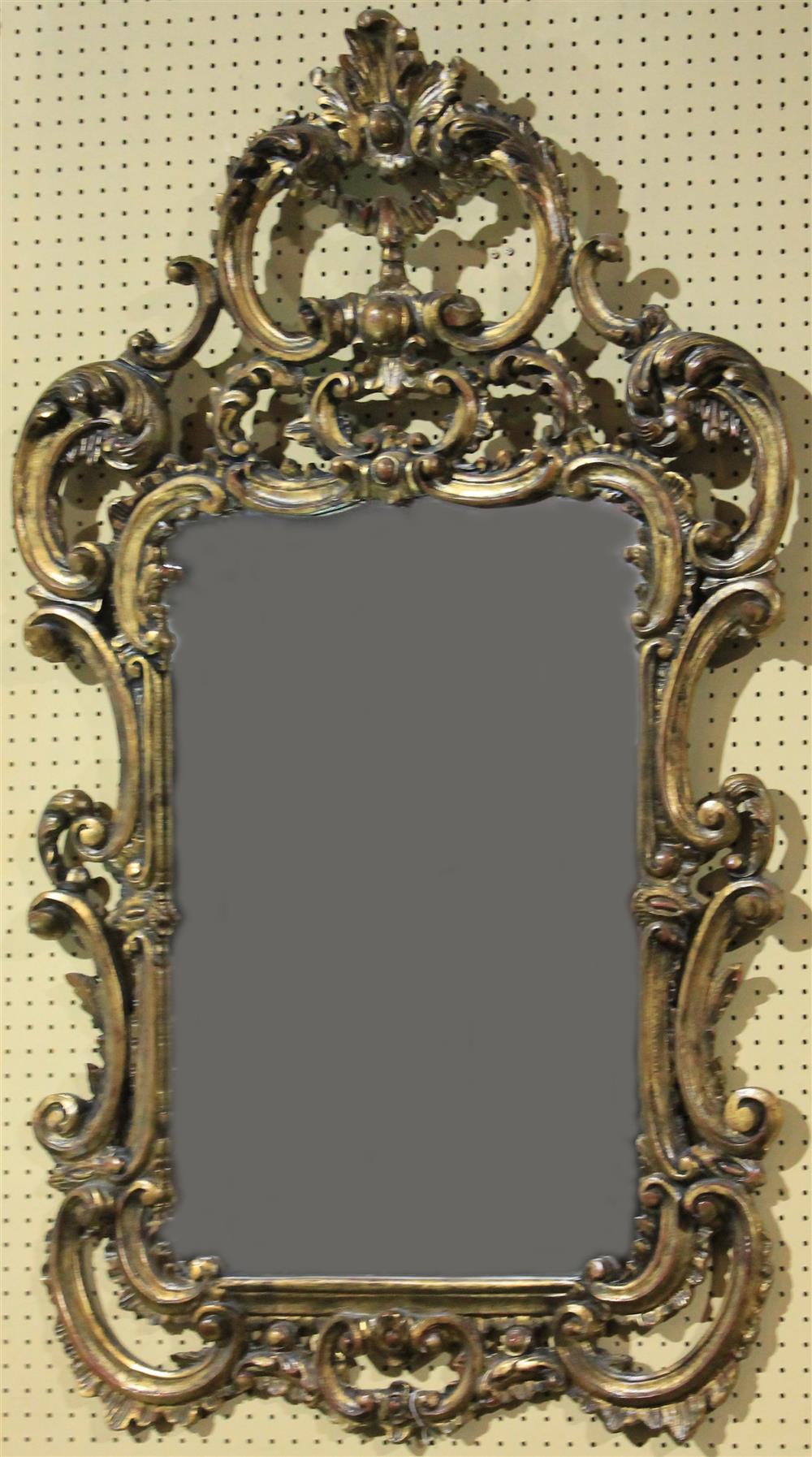 Appraisal: ROCOCO STYLE CARVED AND GILDED MIRROR having a gilded frame