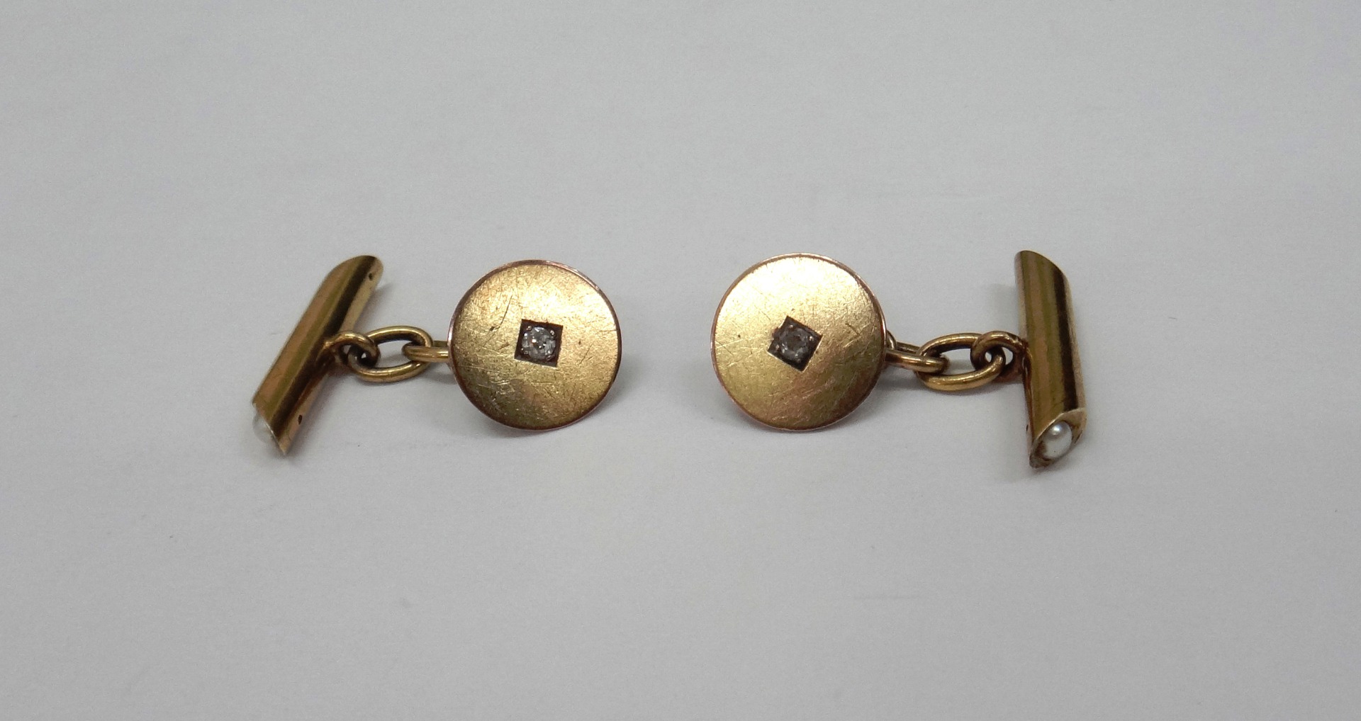 Appraisal: A pair of gold and diamond circular panel cufflinks with