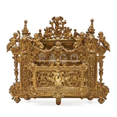 Appraisal: DECORATIVE BRASS LETTER RACK Finely molded cherubs and mask decoration