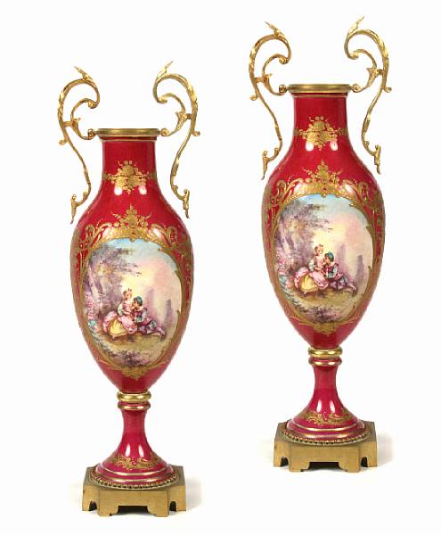 Appraisal: A pair of Sevres style porcelain urns height of each