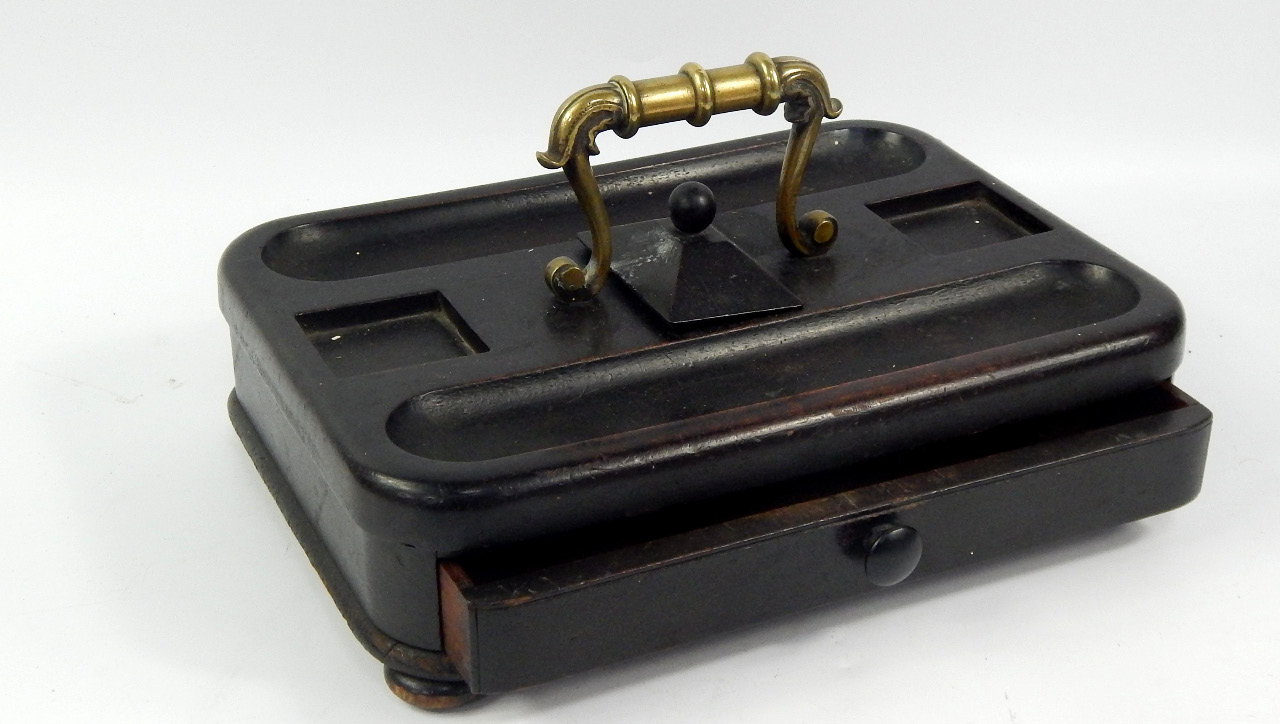 Appraisal: A Victorian ebonised desk stand with brass carrying handle single