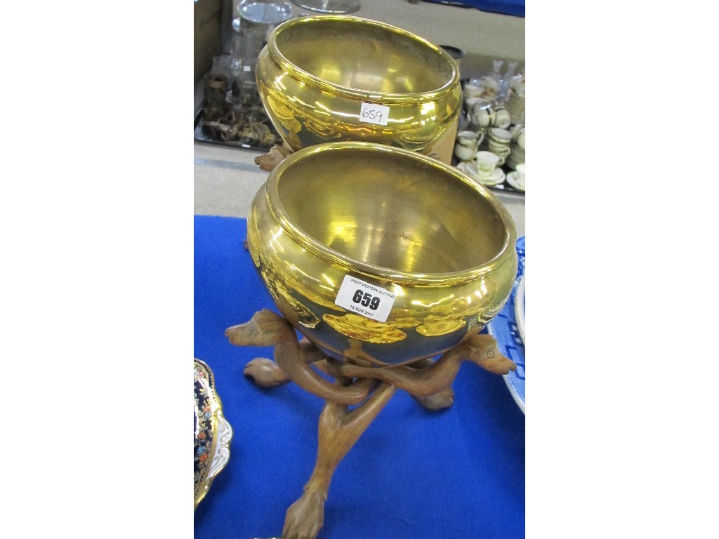 Appraisal: two Indian brass planters on carved wooden stands