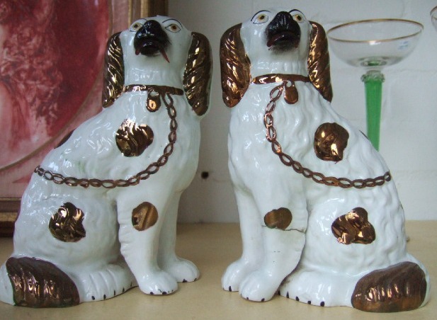 Appraisal: A pair of Staffordshire spaniels th century with gold lustre