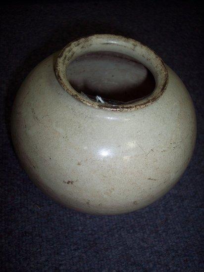 Appraisal: An Oriental globular vase of cream glaze having a flanged