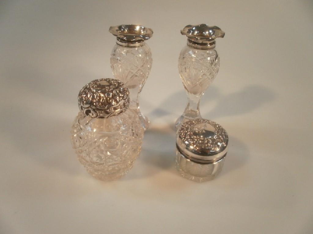 Appraisal: A pair of cut glass silver collared baluster spill vases