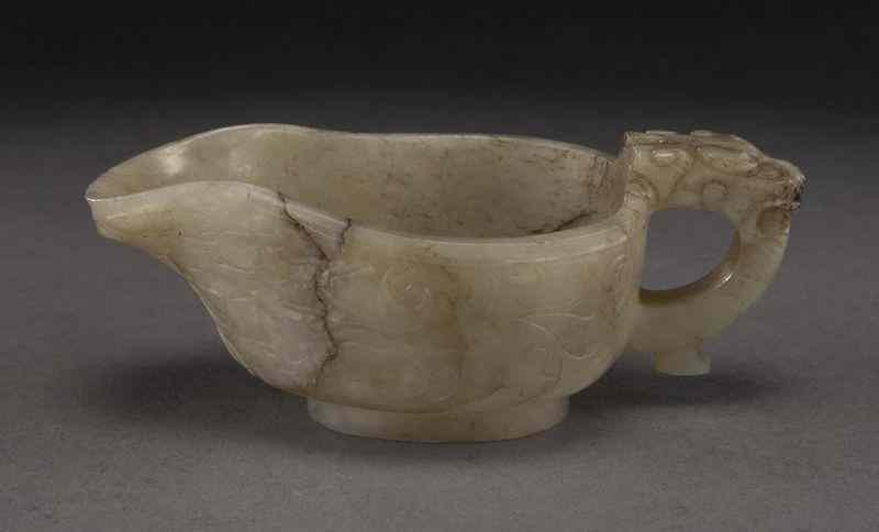 Appraisal: Chinese Ming carved jade libation cup depicting two dragons in