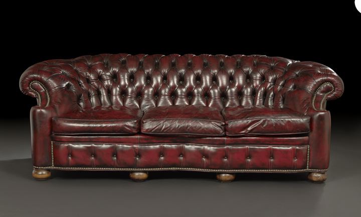 Appraisal: Edwardian-Style Mahogany and Leather-Upholstered Chesterfield Sofa late th century the