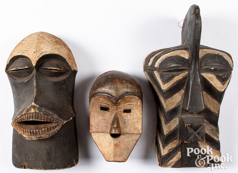 Appraisal: Three African carved and painted masks Three African carved and