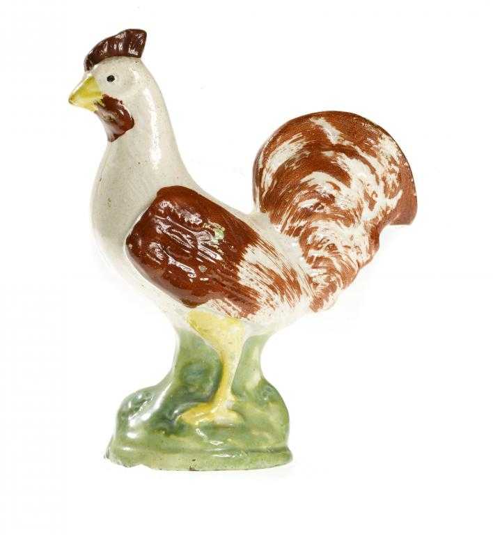 Appraisal: A STAFFORDSHIRE EARTHENWARE MODEL OF A COCKEREL sponged in rust