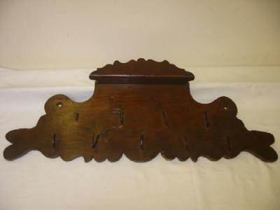 Appraisal: A WALL MOUNTED GAME HANGER in stained beech with wrought