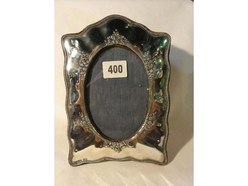 Appraisal: A silver photograph frame with beaded and embossed floral decoration