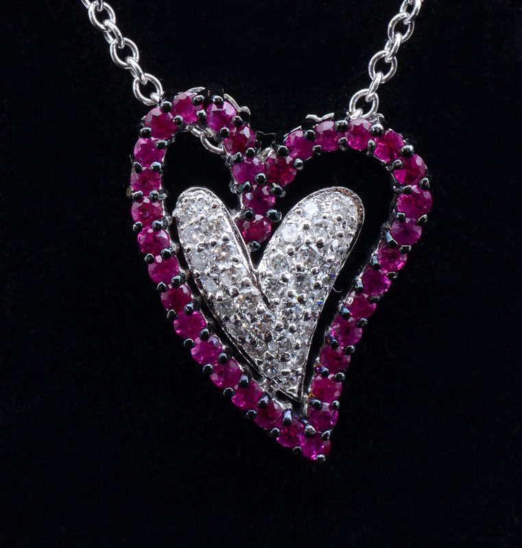 Appraisal: DALI-LIKE HEART PENDANT WITH RUBIES ON K WITH K CHAIN