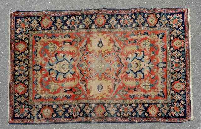 Appraisal: AN OLD PERSIAN RED GROUND RUG decorated the central foliate