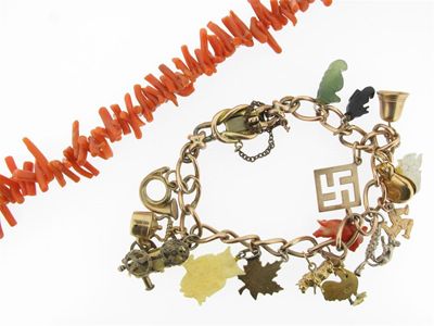 Appraisal: A charm bracelet mounted with assorted charms and a coral