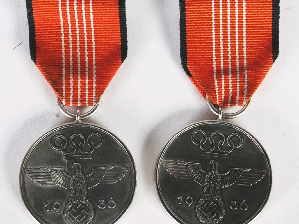 Appraisal: TWO OLYMPIC MEDALS silvered alloy type complete with ribbons and