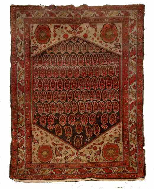 Appraisal: A HAMADAN BROWN GROUND CARPET decorated a central medallion of