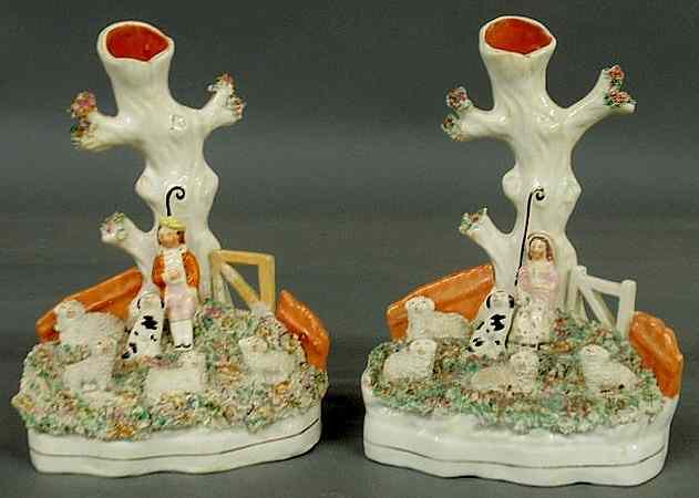 Appraisal: Pair of th c Staffordshire spill vases with shepherds dogs