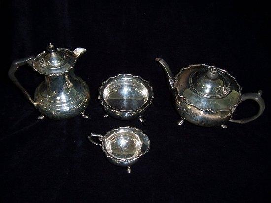 Appraisal: A four-piece tea and coffee set comprising teapot coffee pot