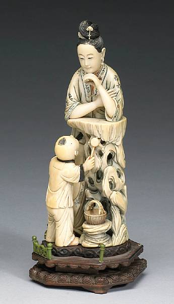 Appraisal: A carved ivory figure of a beauty and a child