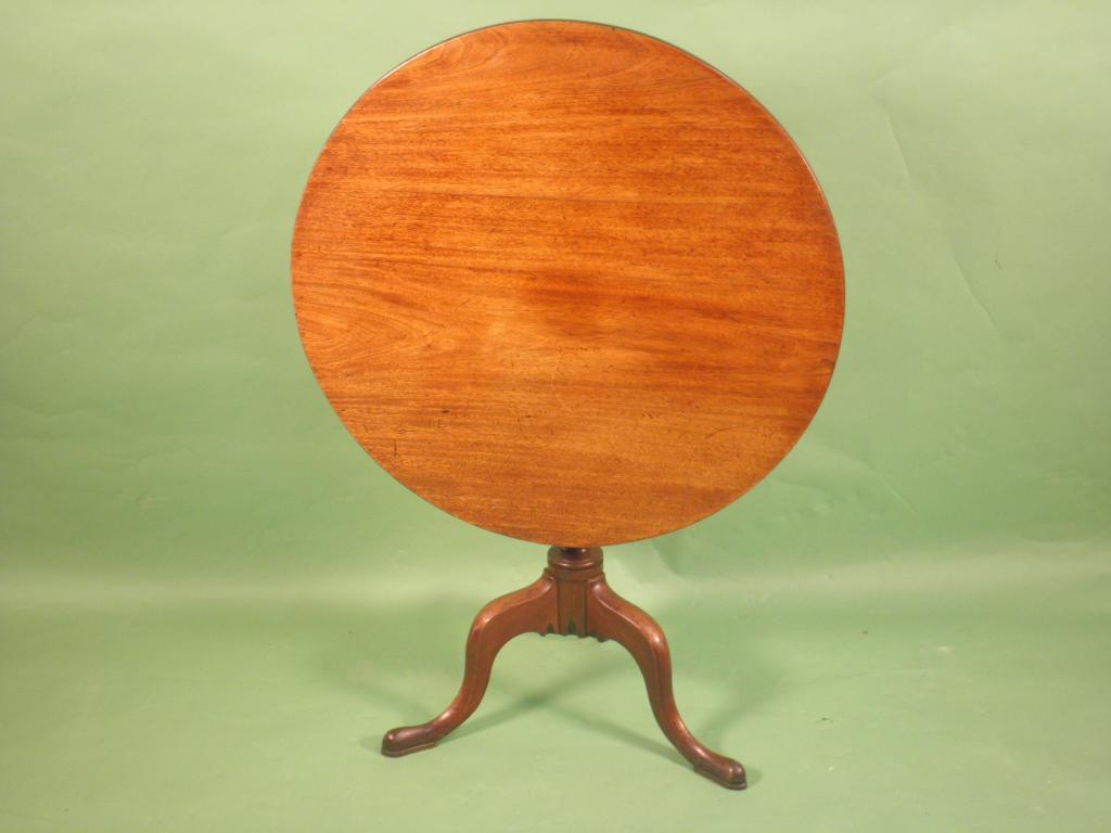 Appraisal: A George III mahogany tilt top table the circular top